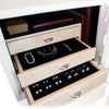 A compact jewelry safe painted a glossy antique white and furnished with a stainless electronic lock and curly maple wood. Luxury upgrades include half moon drawer pulls, necklace rack, and  sand ultrasuede fabric interior.